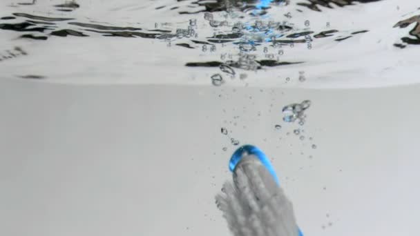 Brush in a super slow motion floating to the surface — Stock Video