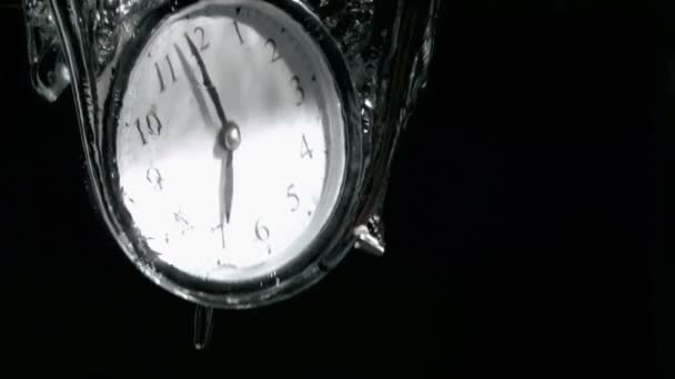 Alarm clock in a super slow motion falling in water — Stock Video