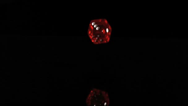 One red translucent dice in a super slow motion turning — Stock Video