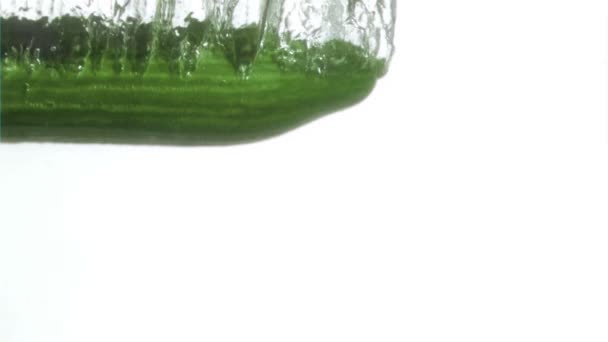 Half cucumber in a super slow motion falling in water — Stock Video