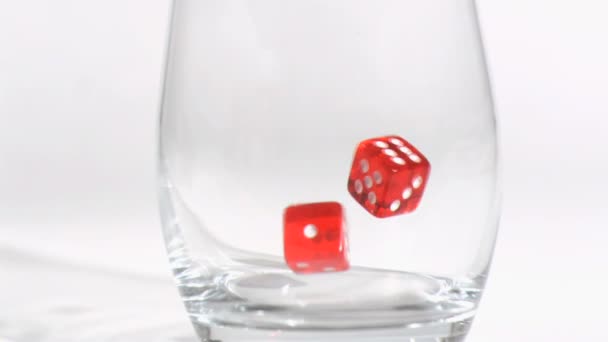 Two red dices in a super slow motion rebounding in glass — Stock Video