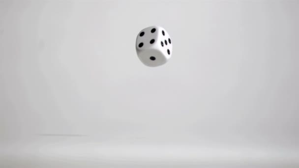 One white dice in a super slow motion rebounding — Stock Video