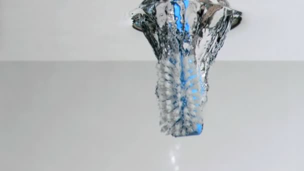 Brush in a super slow motion falling on water against a white background — Stock Video