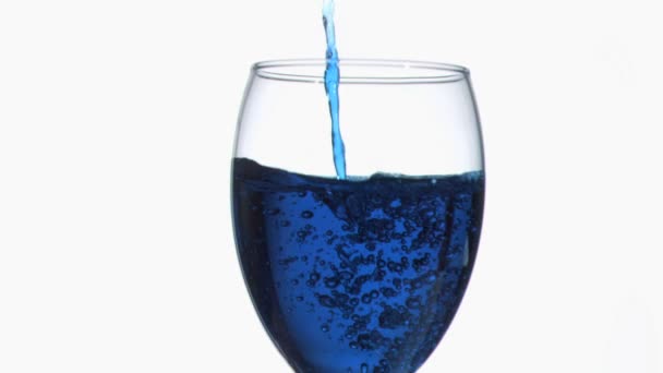 Trickle azul fino em movimento super lento fluindo em um copo de vinho completo — Vídeo de Stock