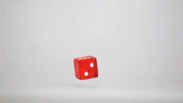 One red dice in super slow motion turning near the floor — Stock Video