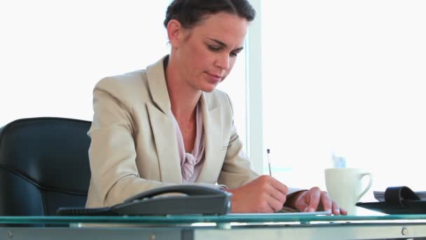 Businesswoman working in her office — Stock Video