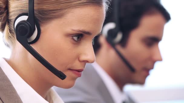 Call centre agent working with a headset — Stock Video