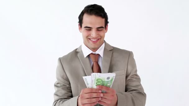 Smiling businessman holding a fan of notes — Stock Video