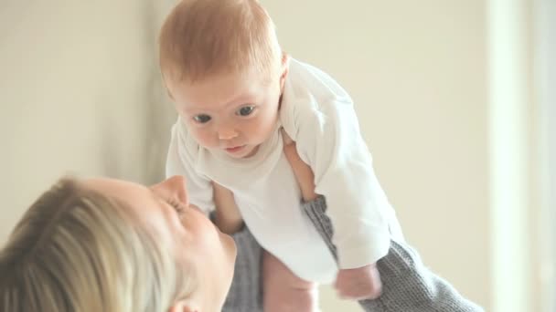 Mujer sosteniendo un bebé por encima de su cabeza — Vídeos de Stock