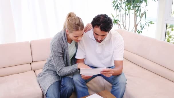 Young man reading a letter with his girlfriend — Stock Video