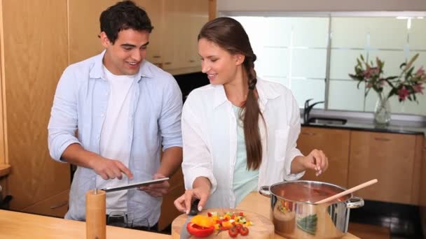 Couple cooking with a tablet computer — Stock Video