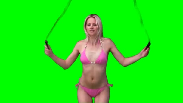 A woman in a bikini skipping and working out — Stock Video