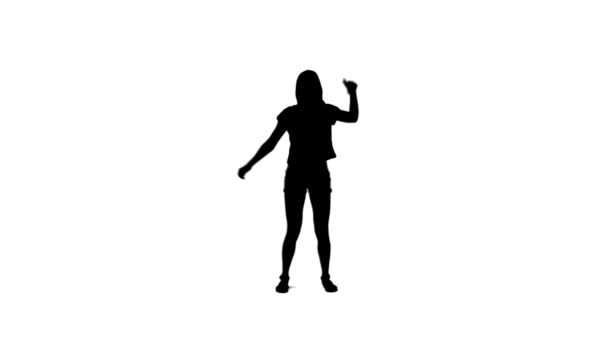 Silhouette of a woman dancing with her arms raised — Stock Video