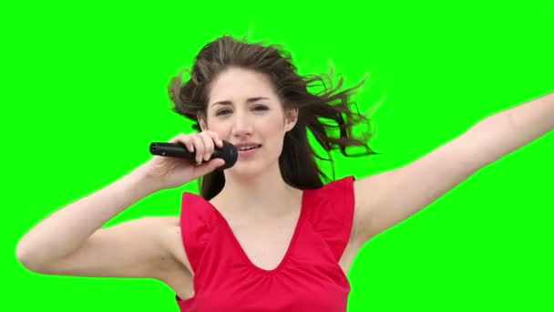 Woman waving her arms while singing into a microphone — Stock Video