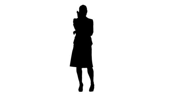 Silhouette of a woman talking on her mobile phone — Stock Video
