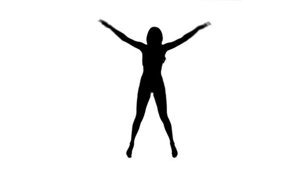 Silhouette of a woman doing star jumps — Stock Video