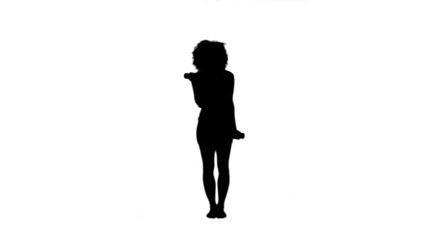 Silhouette of an energetic woman lifting weights — Stock Video
