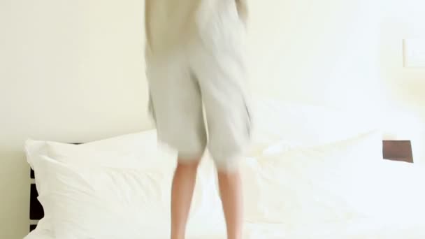 Smiling child jumping on a mattress — Stock Video