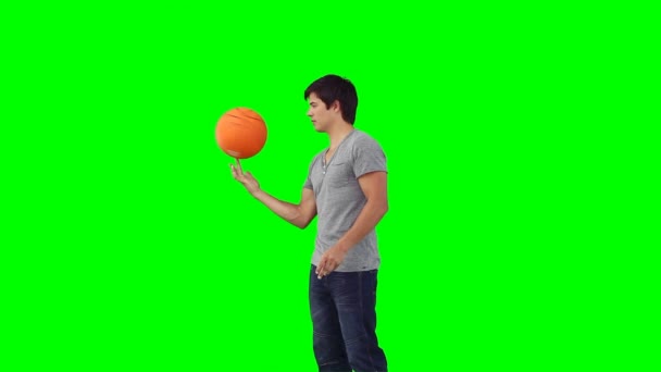 A man spins a basketball on his finger — Stock Video