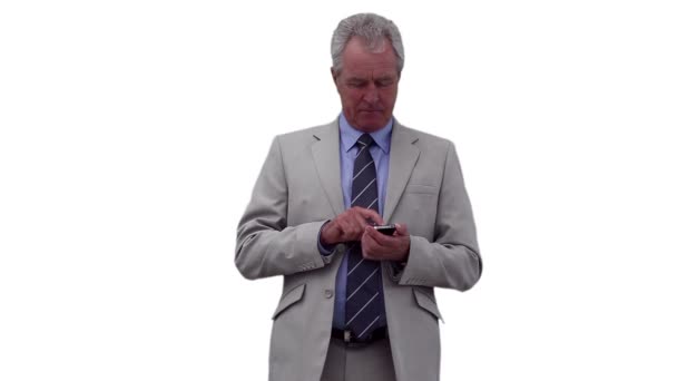 Businessman pressing buttons on his phone before looking around him — Stock Video