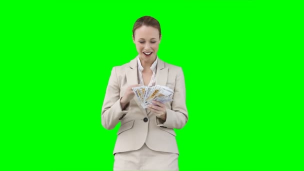 A smiling woman counts and shakes all of her money — Stock Video