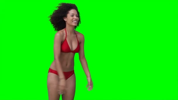 A woman throws a beachball off screen multiple times — Stock Video