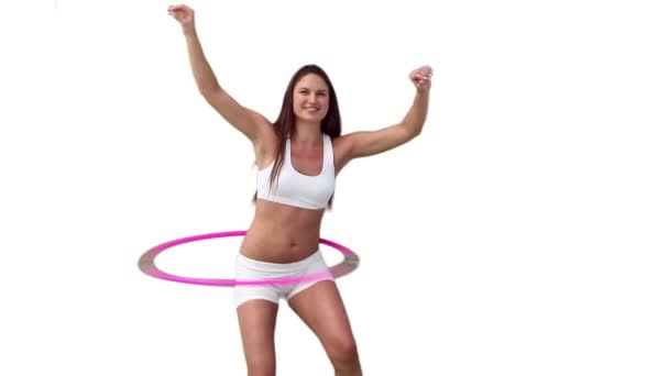 Woman in white training gear playing with a hula hoop — Stock Video