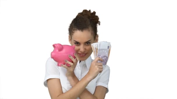 Woman with a piggy-bank and cash in her hands — Stock Video