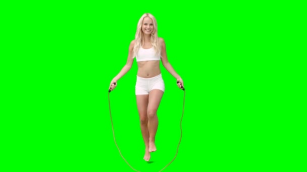 Blonde skipping over a rope — Stock Video