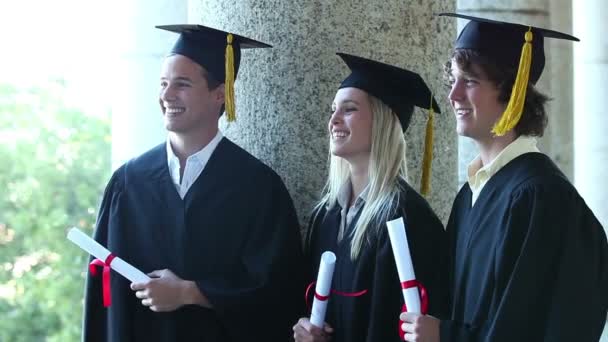 Trhee graduates laughing together — Stock Video