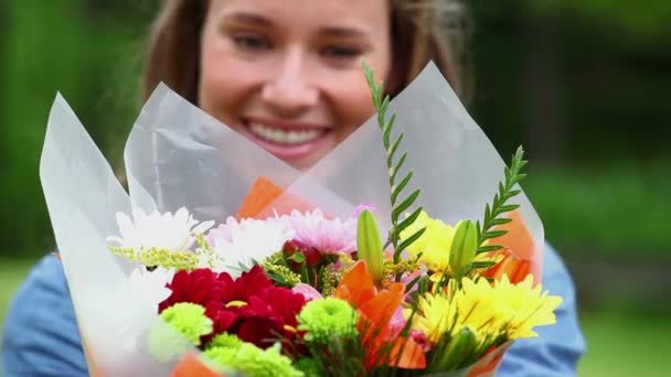 Mujer sonriente sosteniendo flores — Vídeo de stock