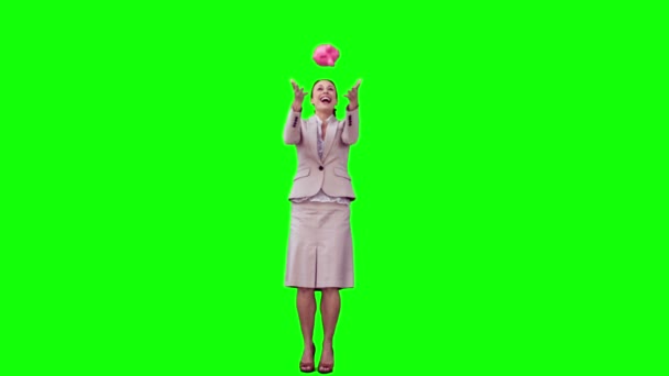 Businesswoman in slow motion throwing a piggy bank — Stock Video