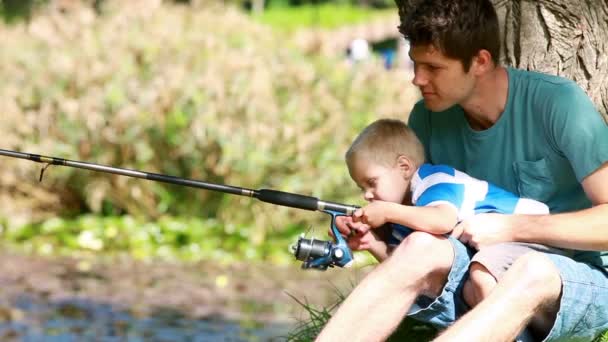 Man fishing with his little boy — Stock Video