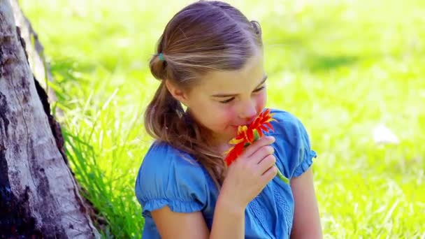 Niña oliendo una flor — Vídeos de Stock