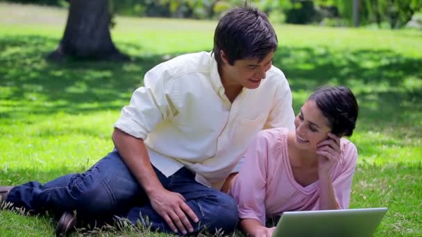 Smiling couple looking at their laptop — Stock Video