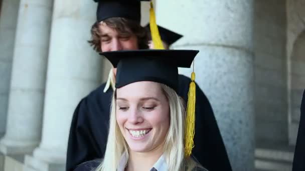 Sonriendo estudiantes graduados fotografiándose a sí mismos — Vídeos de Stock