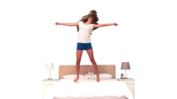 Vrouw stuiteren in slow motion op haar bed — Stockvideo