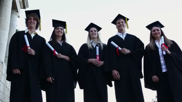 Estudantes graduados a vomitar os chapéus — Vídeo de Stock