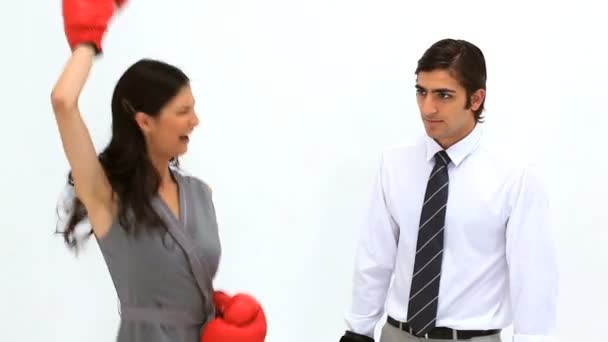 Woman wearing boxing gloves alongside her colleague — Stock Video