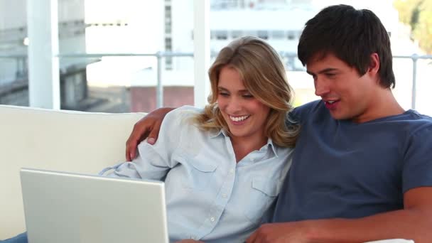 Lovely couple looking at a laptop — Stock Video