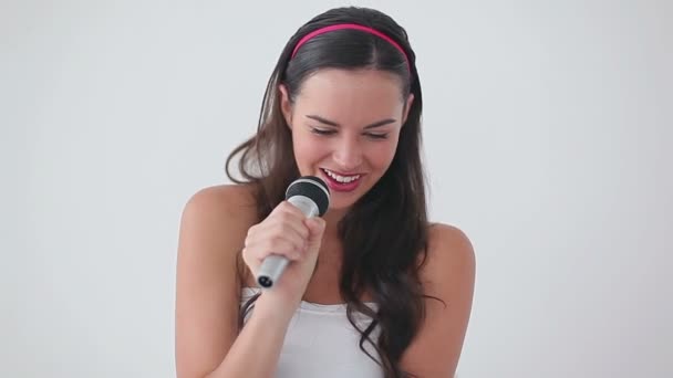 Smiling brunette woman holding a microphone — Stock Video