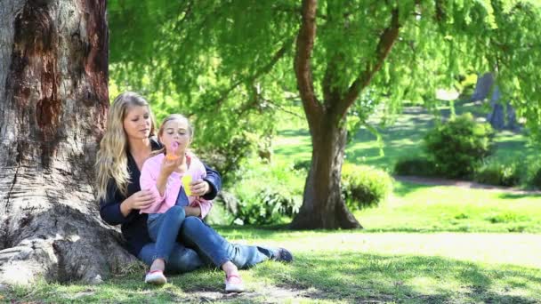 Girl and her mother doing bubbles — Stock Video