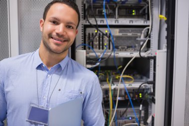 Man smiling in front of the servers clipart