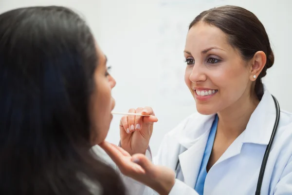 Woman's mouth being examined by happy doctor — Stock Photo, Image