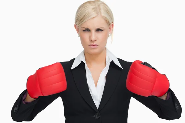 Serious businesswoman wearing red gloves — Stock Photo, Image