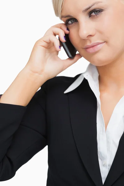 Close-up of a green eyed businesswoman using her mobile — Stock Photo, Image