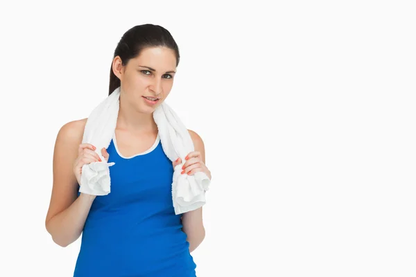 Brunette in sportswear with a towel — Stock Photo, Image