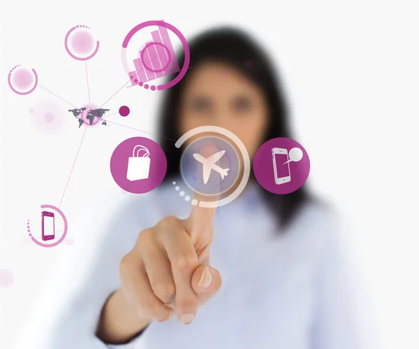 Woman selecting airplane symbol from interface — Stock Photo, Image