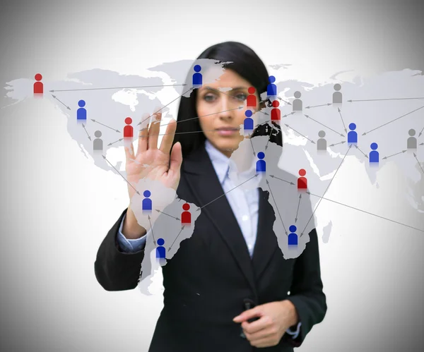 Businesswoman touching world map interface — Stock Photo, Image