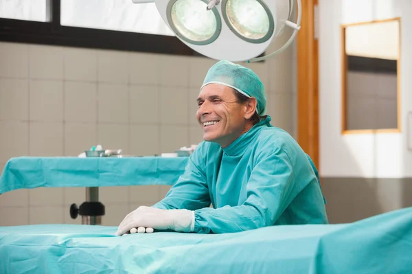 Happy surgeon sitting in operating theatre — Stock Photo, Image